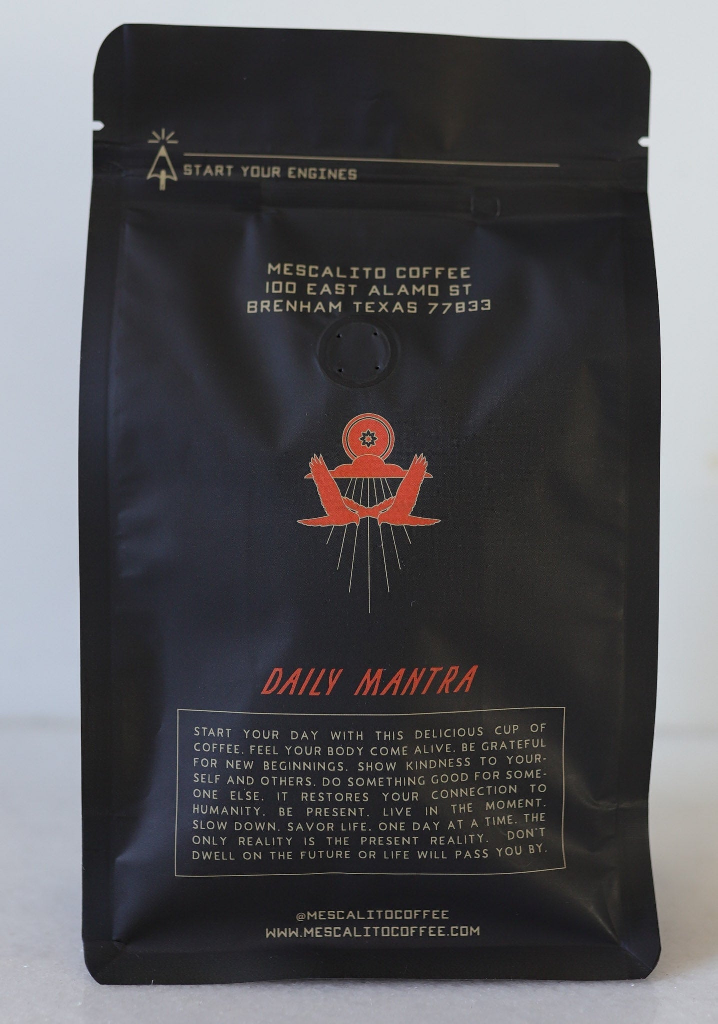 A black bag of Mescalito Coffee labeled "Blend Whole Coffee Beans | Kalimaz" features an address, a red illustration, and a paragraph highlighting Ethiopian Guji Kalimaz beans with extended fermentation for enhanced flavor.